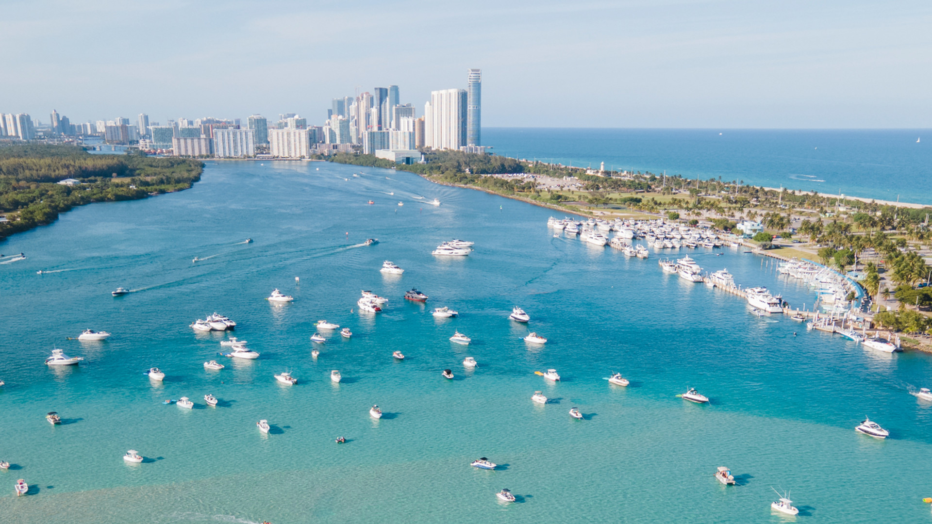 Sunlit turquoise waters, yachts and the Miami Beach skyline